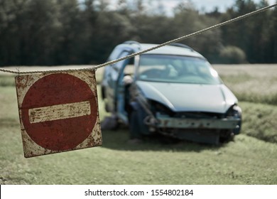 Damaged car and stop sign at one shot