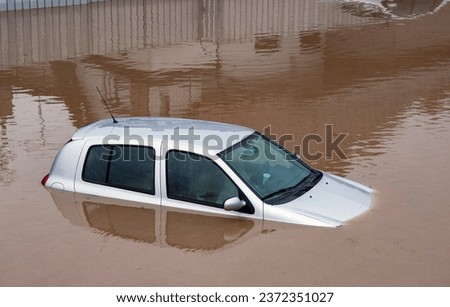 Damaged car under the water on flood, insurance issue
