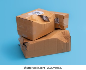 Damaged cardboard box with hole on blue background,cardboard box destroyed in shipping - Shutterstock ID 2029950530
