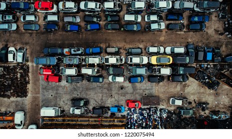 Damaged cars waiting in a scrapyard to be recycled or used for spare part - Shutterstock ID 1220075494