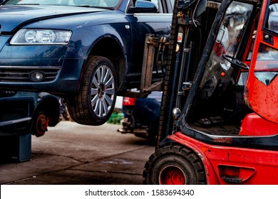 Damaged cars waiting in a scrapyard to be recycled or used for spare part - Shutterstock ID 1583694340