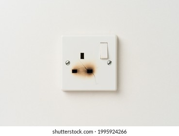 Damaged Electrical Domestic Power Socket With Cracks And Burn Marks