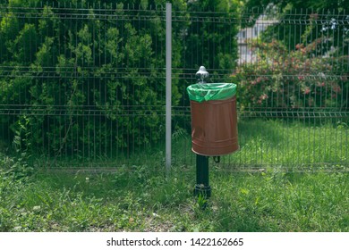 Damaged Garbage Bin Inside Public Park. Environmental Concept