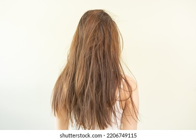 Damaged hair, frustrated asian young woman, girl in splitting ends, messy unbrushed dry hair and frizzy with long disheveled hair, health care of beauty. Portrait isolated on background, Back view. - Shutterstock ID 2206749115