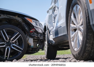 Damaged in heavy car accident vehicles after collision on city street crash site. Road safety and insurance concept - Shutterstock ID 2094946816