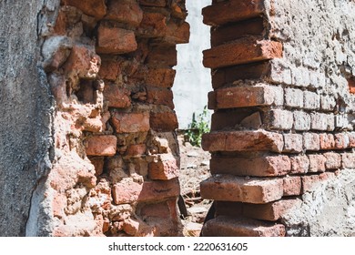 Damaged Home Exterior After An Earthquake Or Natural Disaster With Fallen Wall Made Of Bricks And Cement