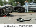 Damaged motorbike and car on the city road at the scene of an accident. Broken and wrecked motorcycle on road