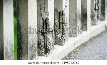 Damaged old reinforced concrete pillars, Cracked concrete surface with visible rusty reinforcement of bridge