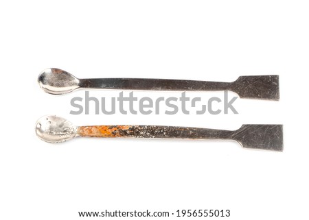 Damaged with oxidation metal laboratory spoon, spatula isolated on white background. Metal Laboratory Equipments. Lab spatulas reagent lab sampling used in laboratory.