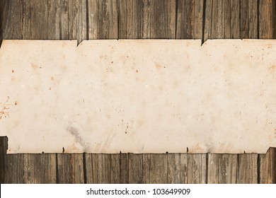 Damaged paper roll on a wooden background