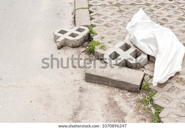Damaged\
parking lot space tiles and bricks\
pavement
