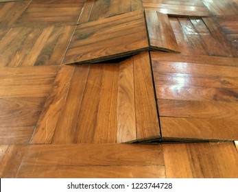 Damaged parquet floor because of humidity and moisture, bending and come out, image captured by smartphone