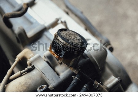 Damaged piston of a motorcycle engine.
