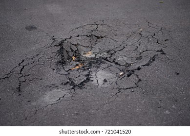 Damaged road. Deep crack on the asphalt. 