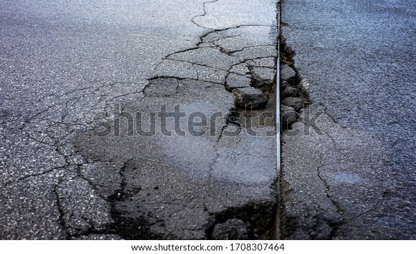 Damaged road that needs\
some repair work