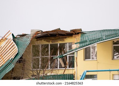 Damaged Roof Of A Building. Strong Wind, Tornado, Storm Concept