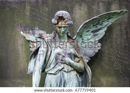 damaged sculpture of a female angel statue  on cemetery