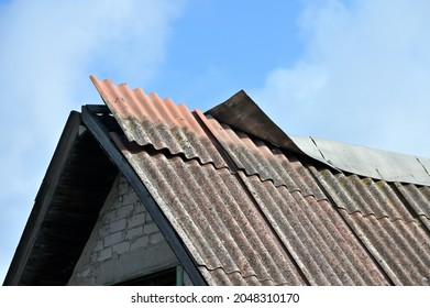 Damaged Slate Roof Piece On A Pitched Roof On A Derelict House