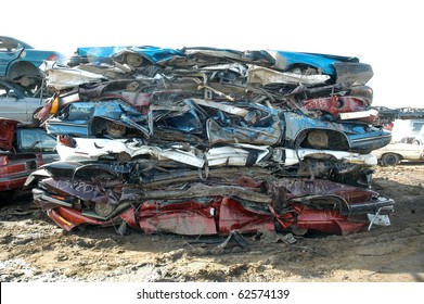 Damaged Squashed Cars In A Junk Yard