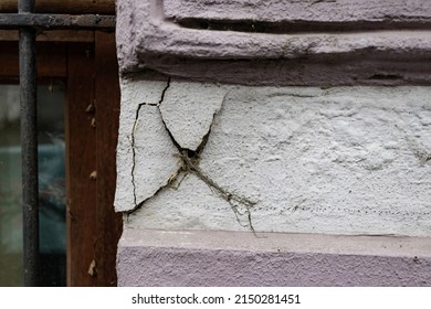 Damaged stucco on the wall. Crumbling stucco on the corner.
