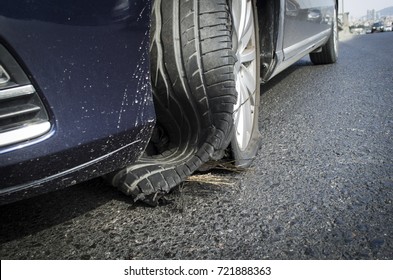 damaged tire after tire explosion at high speed on highway - Shutterstock ID 721888363