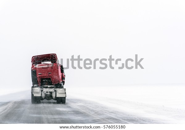 Damaged truck
moving on the snow-covered
road