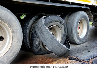 Damaged truck tires.damaged 18 wheeler semi truck burst tires by highway street.damaged tire after tire explosion at high speed on highway.