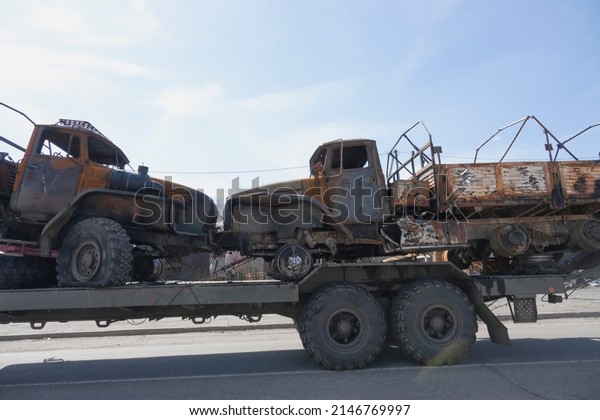 Damaged trucks go for recycling. Burnt\
military equipment.