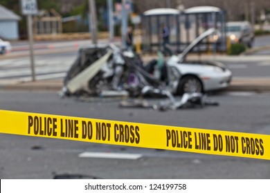 Damaged Vehicle After Car Accident Behind Police Line Do Not Cross Barrier Tape