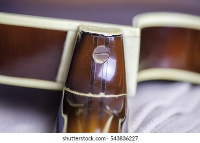 A Damaged Vintage Guitar Neck Joint. A Broken Guitar Neck Joint That Has Been Badly Repaired.