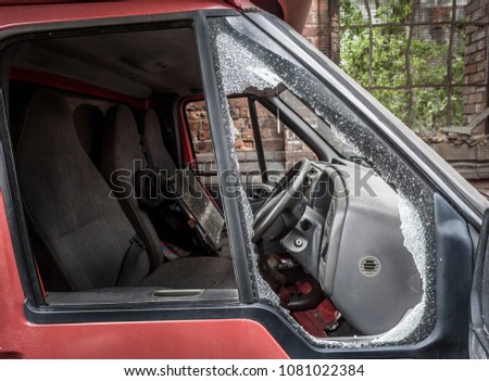 Damaged window pane of a van cracked by theft.