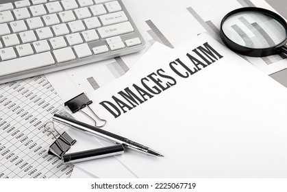 DAMAGES CLAIM Text On A Paper With Chart And Keyboard, Business Concept