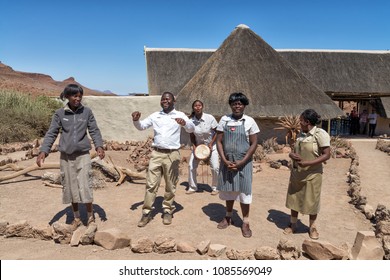 DAMARALAND, NAMIBIA - September 6, 2015: Damaraland Camp Employees Wish Goodbye To Tourists Who Are Leaving The Camp After Their Stay, By Giving A Local Song And Dance Performance.