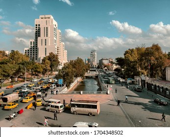 Damascus / Syria - 01 07 2020: Shukri al-Quwatli street in central Damascus next to Barada river, Syrian Ministry of Tourism,  National Museum of Damascus, Four Seasons Hotel and Tekkiye Mosque.
