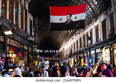 Damascus, Syria -May, 2022: Portrait image of Bashar al-Assad, President of Syria on syrian flag at Suq in Damascus