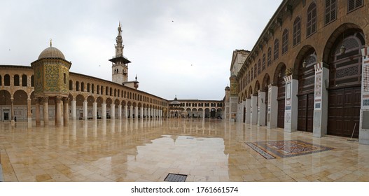 Damascus,Syria 03/28/2010: panorama of the  courtyard of the famous Umayyad Mosque a.k.a the Great mosque of Damascus.  Image shows minarets, marble floor, arches and pillars.