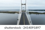 The Dames Point Bridge in Jacksonville, Florida, captured in daylight with cars driving over and water underneath.