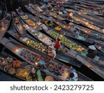 Damnoen Saduak Floating Market or Amphawa. Local people sell fruits, traditional food on boats in canal, Ratchaburi District, Thailand. Famous Asian tourist attraction destination. Festival in Asia.