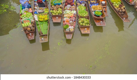 Damnoen Saduak Floating Market or Amphawa. Local people sell fruits, traditional food on boats in canal, Ratchaburi District, Thailand. Famous Asian tourist attraction.