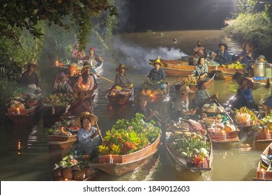 Damnoen Saduak Floating Market Or Amphawa. Local People Sell Fruits, Traditional Food On Boats In Canal, Ratchaburi District, Thailand. Famous Asian Tourist Attraction Destination. Festival In Asia.