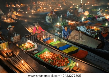 Damnoen Saduak Floating Market or Amphawa. Local people sell fruits, traditional food on boats in canal, Ratchaburi District, Thailand. Famous Asian tourist attraction destination. Festival in Asia.