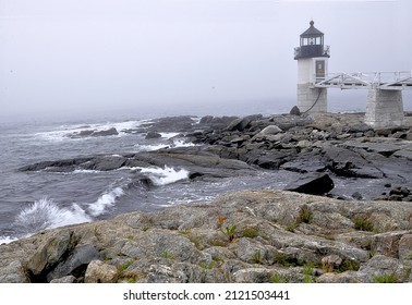 Damp Ocean Fog And Waves Crashing Along Rocky Shoreline At Historic Marshall Point Light In Port Clyde, Maine.