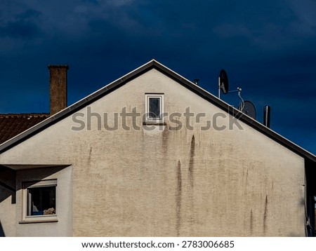 Damp and soiled facade on an old building