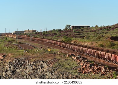 DAMPIER, WA - JUNE 07 2022:Iron ore train in Port of Dampier, Western Australia. Australia, the world's biggest iron ore miner, currently mines 25 billion tonnes of iron ore a year