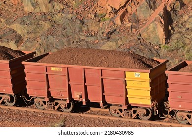 DAMPIER, WA - JUNE 07 2022:Iron ore train in Port of Dampier, Western Australia. Australia, the world's biggest iron ore miner, currently mines 25 billion tonnes of iron ore a year