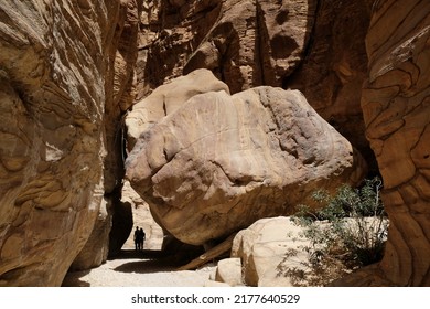 Dana Biosphere Reserve in Jordan. Amazing rocks in Wadi Ghuweir Canyon. Silhouette of hiking person on trail. 