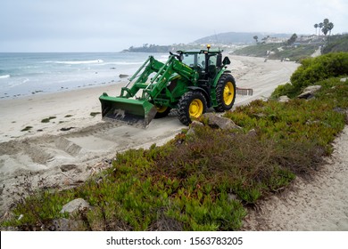 Dana Point, California, US - August 6, 2019
Tractor Doing Beach Cleanup After Storm 