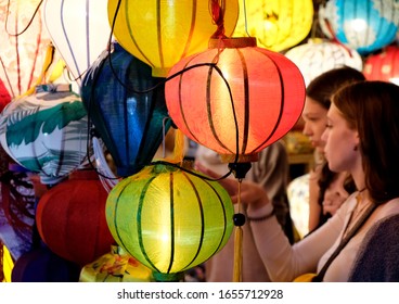 Danang, Veitma. 25 Feb, 2020 : Selective focus A woman is buying a lamp in a lamp shop. Lamp in the Shop for sale at HoiAn ancient town, 