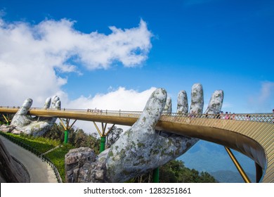 Danang, Vietnam - December 2, 2018: The Golden Bridge with blue sky on Ba Na Hill in Danang, Vietnam. Ba Na Hill mountain resort is a favorite destination for tourists for travel.