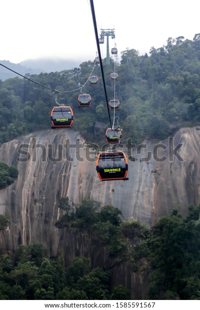 Danang, Vietnam - NOV 25, 2019: On a foggy day,\
the cable car to the resort location of Ba Na Hills Mountain\
Resort, the longest non-stop single cable car track is 5,801\
meters, Da Nang. ,\
Vietnam